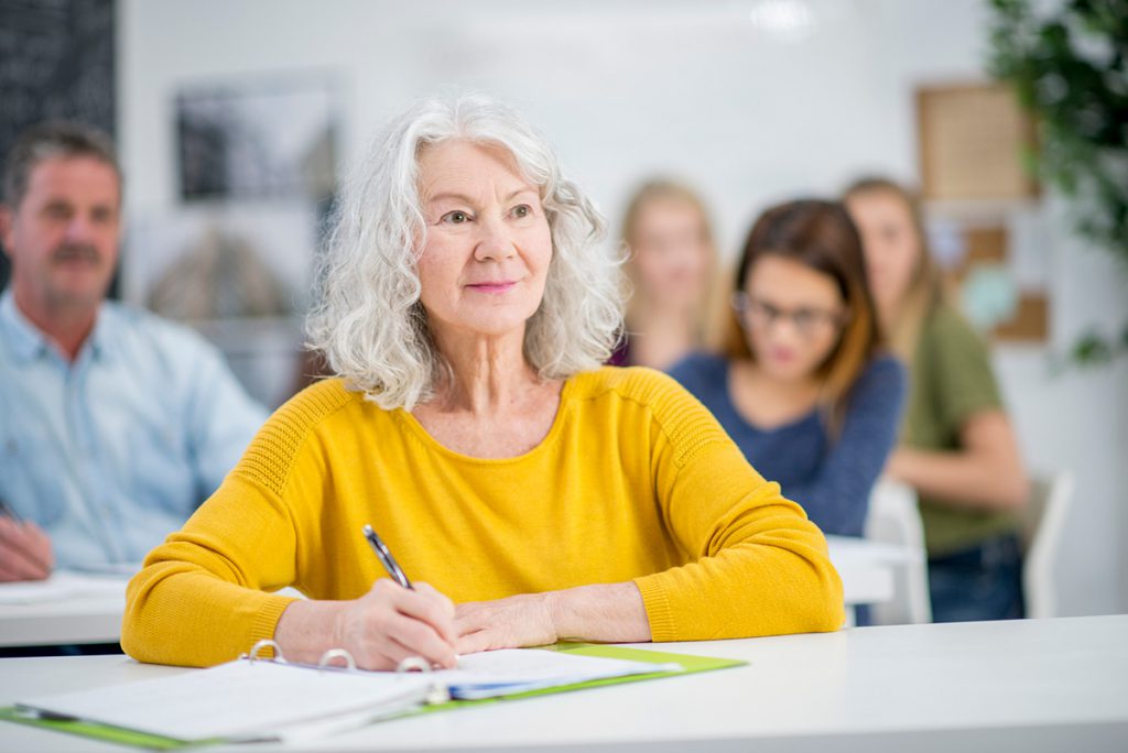 older woman in a classroom for a story on why you're never too old to learn something new