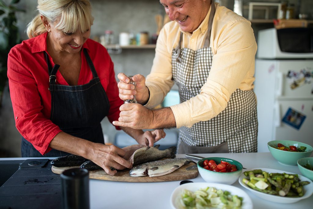 older couple cooking for a story on the MIND diet