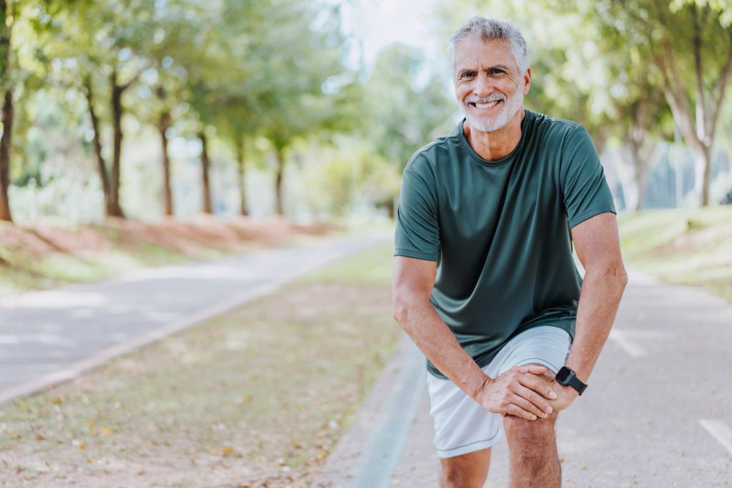 Happy senior man exercising outside for a story on lower body balance exercises